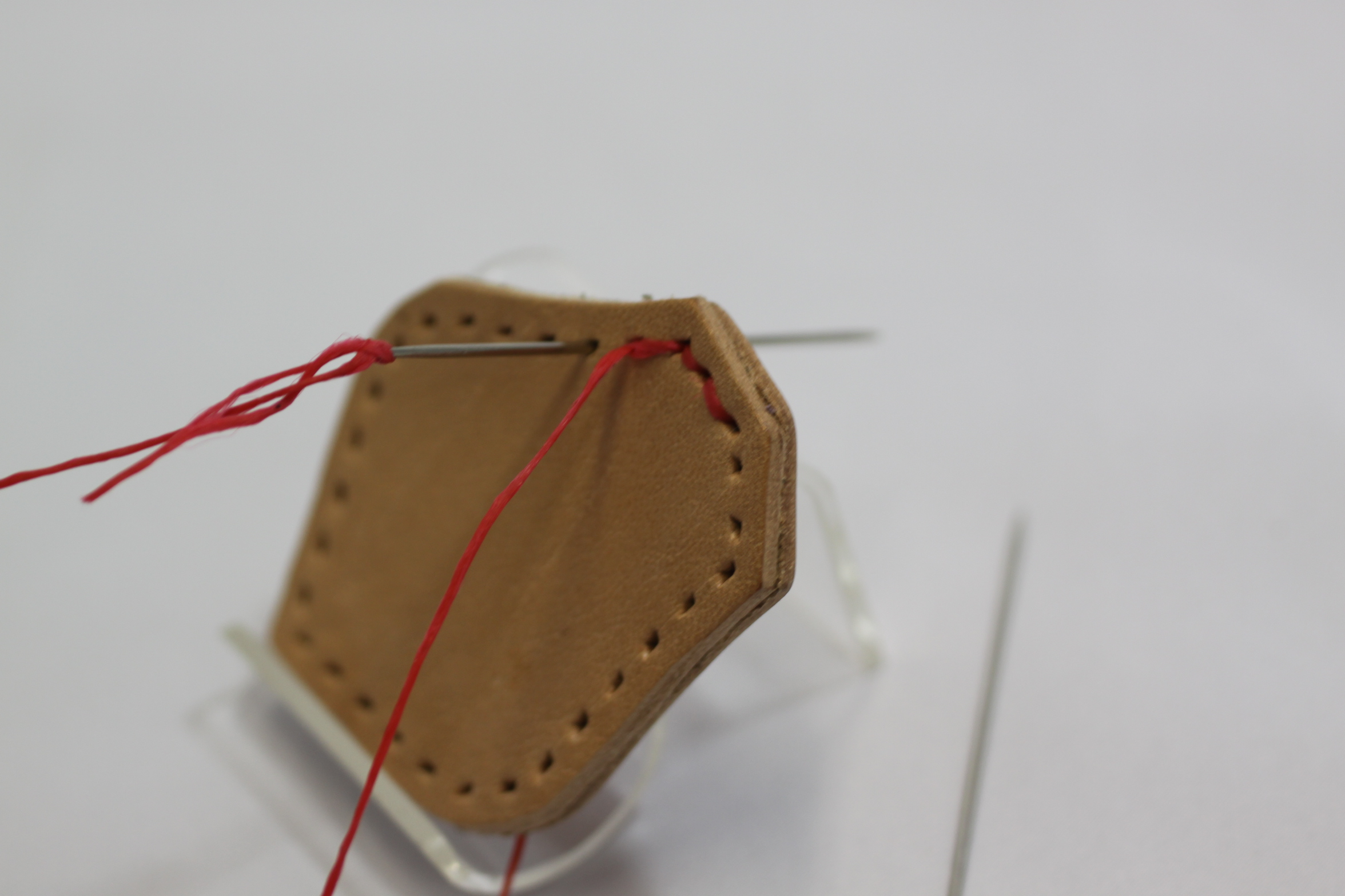 穴あけ後の手縫い作業です。