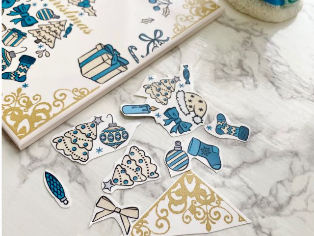 絵柄シートをハサミできりとりお水につけて貼り付けていきます。どのパーツをどこへ貼ろうかな、、、。