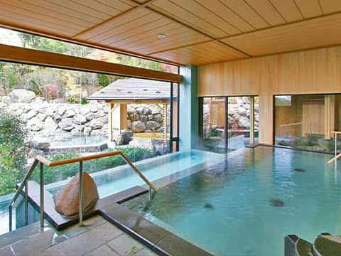 季の湯(男性浴場)【大浴場】広々とした石造りの大浴場。開放感のある窓ガラスの外には、四季折々の表情を見せる六甲の自然が広がります。