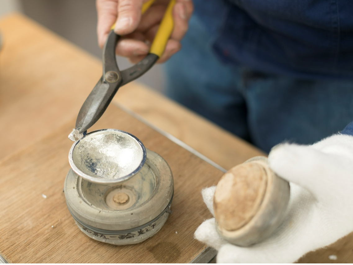 タイミングを計って中子を外し、水で濡らした刷毛で冷やし、さかずきの形になったイコミ状態のものを取り出します。