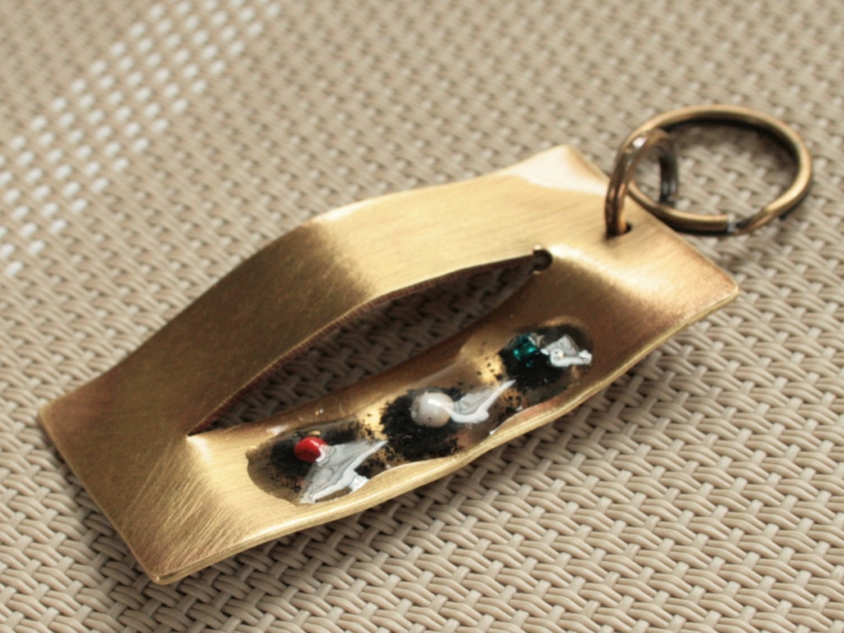 真鍮板を流れるような曲線に曲げた美しいフォルムに桜島の灰が・・・